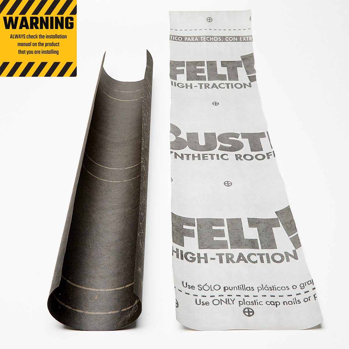 Two roofing materials lie side by side: a black rolled felt on the left and a white synthetic roofing sheet on the right, both ready for installation.