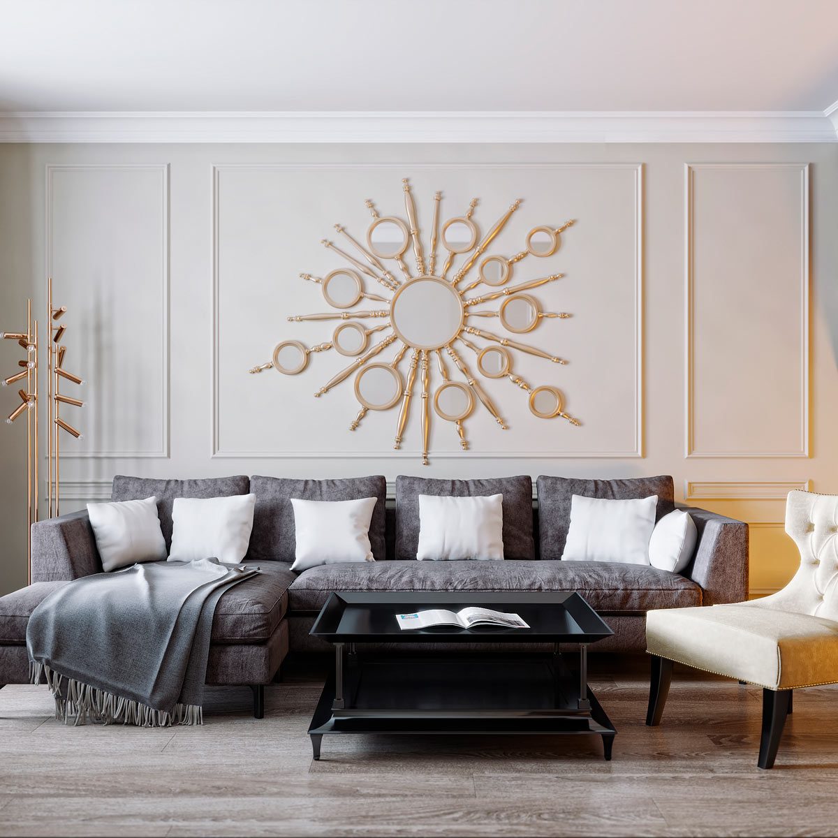 A gray sectional sofa with white pillows sits in a living room, facing a black coffee table and a decorative mirror on the wall.