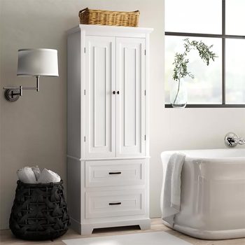 A white cabinet stands against a wall, flanked by a reading lamp and a bathtub, with a basket on top and towels in a woven basket nearby.
