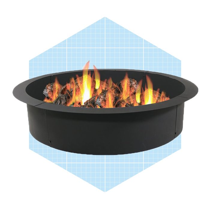 A round fire pit displays flames dancing over dark rocks, set against a light blue geometric background.