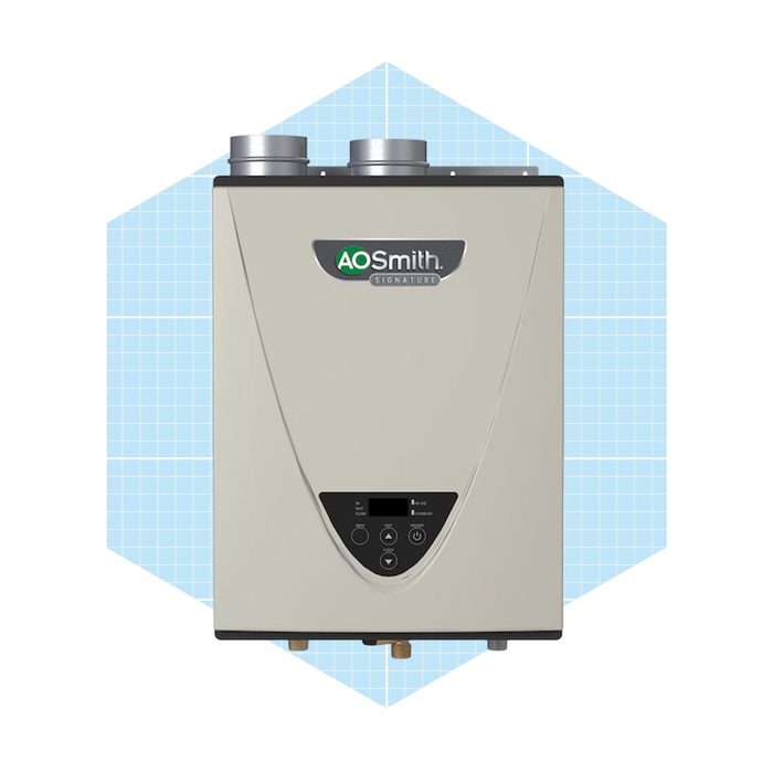 A gray water heater stands upright, featuring control buttons and two metal pipes, set against a light blue geometric background.